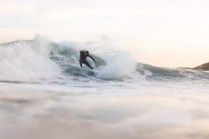 A surfer makes thermost of a new sas it well wraps into south-facing beaches in Wellington, New Zealand.