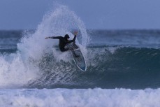 A surfer turns on a section during a small winter swell at Blackhead, Dunedin, New Zealand.Photo: Derek Morrison