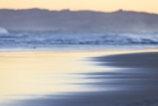 Evening light reflects off the sand at Blackhead, Dunedin, New Zealand.