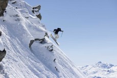 A skier drops off the summit during a powder day at Treble Cone ski field, Wanaka, New Zealand.