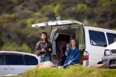 Travellers at Manu Bay, Raglan, Waikato, New Zealand.