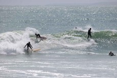 Three-up during a spring swell at Manu Bay, Raglan, Waikato, New Zealand.