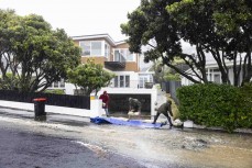 Residents work to sandbag against flooding at St Clair Beach's iconic Cliffs Road during a red heavy rain warning that caused a state of emergency to be declared due to widespread flooding from October 3- October 4, 2024 in Dunedin, New Zealand.
Photo: Der