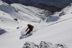Tony James of the Sidehit Podcast hunts for fresh lines over ther back of Cardrona ski field, Cardrona Valley, Wanaka, New Zealand.