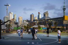 Friends play basketball on dusk at a court faciltiy near the silo city near downtown Auckland, New Zealand.Photo: Derek Morrison