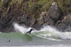 Alexis Owen full wrap during a swell on the north coast of Dunedin, New Zealand.