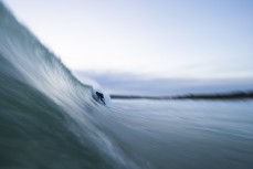 A surfer drops into wave during a small swell at St Kilda, Dunedin, New Zealand.Photo: Derek Morrison