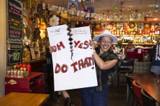 Mandy Down, of Te Arawa, holds her sign at the Sweet Mother's Kitchen cafe ahead of the hīkoi mō te tiriti, Wellington, New Zealand. November 19, 2024.Photo: Derek Morrison