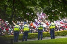 A policewoman stretches during the hīkoi mō te tiriti, Wellington, New Zealand. November 19, 2024.Photo: Derek Morrison