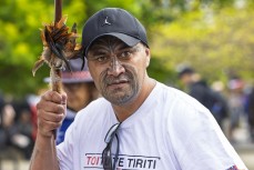 Jharone-Kade Paora Ruri, of Murupara, wields Dame Whina Cooper's taiaha, which hadn't touched the ground since she led the land march to Parliament in 1975, ahead of the hīkoi mō te tiriti, Wellington, New Zealand. November 19, 2024.Photo: Derek Morriso