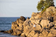 Melissa rockhops around Moturiki Island, Mount Maunganui, Bay of Plenty, New Zealand. Photo: Derek Morrison