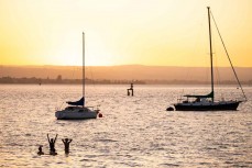 Sunset swimmers Pilot Bay, Mount Maunganui, New Zealand. Photo: Derek Morrison