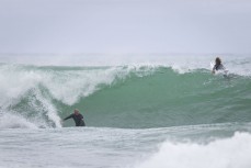 A surfer drops below sea level during a swell on the north coast of Dunedin, New Zealand.