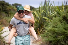 Jai Earnshaw piggybacks his mum to the prizegiving at the Cape Classic held at Tauranga Bay, Westport, West Coast, New Zealand.