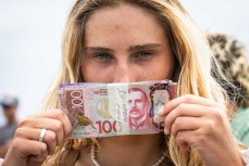 Ava Henderson with $1000 prizemoney she won at the Cape Classic held at Tauranga Bay, Westport, West Coast, New Zealand.