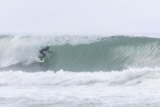 Luke Rogers deep on an open one during a swell on the north coast of Dunedin, New Zealand.