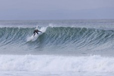 Keo Morrison, hand in the wall, during a swell on the north coast of Dunedin, New Zealand.