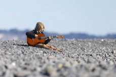 Young musician at a surf break near Kaikoura, New Zealand. Photo: Derek Morrison