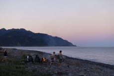 Kalani Summerton and Thomas Owen enjoy a boardies surf under the full moon at a surf break near Kaikoura, New Zealand. Photo: Derek Morrison