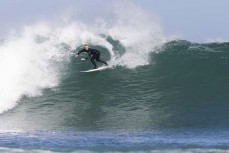 Alexis Owen at a remote reef break in the Catlins, New Zealand. Photo: Derek Morrison