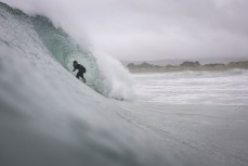 James Charlesworth gets barrelled during a swell on the north coast of Dunedin, New Zealand.