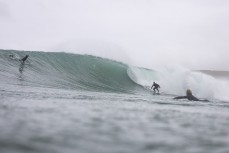 Lee Morris, 58, drops into a set wave during a swell on the north coast of Dunedin, New Zealand.