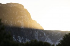 Morning light spills over cliffs at a remote beach break in the Catlins, New Zealand. Photo: Derek Morrison