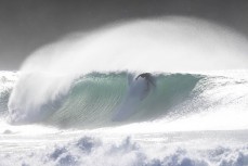 A surfer rides a wave at a remote beach break in the Catlins, New Zealand. Photo: Derek Morrison