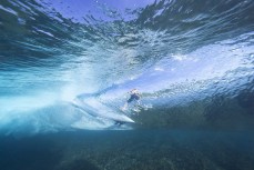 Keo Morrison rides a wave at a remote right reefbreak in the Mentawai Islands, Sumatra, Indonesia.