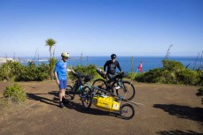 Adventurers Huw Kingston and Laurence Mote prepare to ride from Cape Reinga to Slope Point to raise awareness for climate change. Here they tackle the first section at Cape Reinga, Northland, New Zealand.
