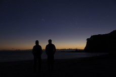 Adventurers Huw Kingston and Laurence Mote prepare to ride from Cape Reinga to Slope Point to raise awareness for climate change. Here they watch the stars of matariki rise near Cape Reinga, Northland, New Zealand.