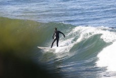 Surfer at the point at St Clair, Dunedin, New Zealand.
