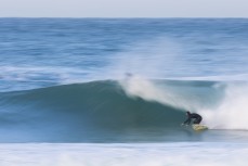 A surfer makes the most of raw winter lines at Blackhead, Dunedin, New Zealand.