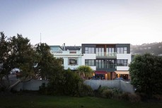 New apartment and dining establishments on a calm winter's evening at St Clair, Dunedin, New Zealand.