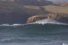 Giant waves from a southerly swell roll into the coastline on the Otago Peninsula, Dunedin, New Zealand.