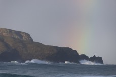 Giant waves from a southerly swell roll into the coastline on the Otago Peninsula, Dunedin, New Zealand.