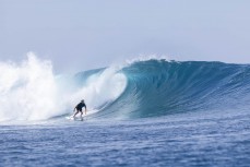 Keo Morrison on a set wave in the Mentawai Islands, Sumatra, Indonesia.