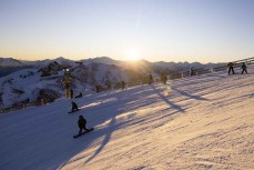 Keo Morrison and Noel Saxon on dusk at Coronet Peak ski field, Queenstown, Central Otago, New Zealand.
