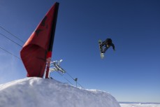A snowboarder jumps the Stag line at Cardrona ski field, Cardrona Valley, Wanaka, New Zealand.
