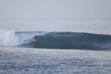 Keo Morrison makes the most of a magic run of swell continues at dawn at a remote lefthand reefbreak in the Mentawai Islands, Sumatra, Indonesia.