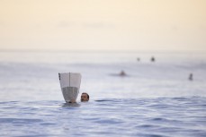 Brett Wood with his broken board at a remote right hand reefbreak in the Mentawai Islands, Sumatra, Indonesia.