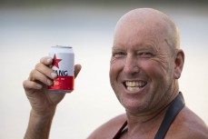 Dave Lyons enjoys a Bintang at a remote right hand reefbreak in the Mentawai Islands, Sumatra, Indonesia.