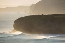 Surf rolls in at a secluded break near Dunedin, New Zealand.