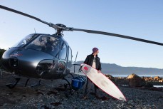 Dallas Hewett prepares to surf during a heli-surf trip to Big Bay, West Coast, New Zealand. 