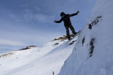 Keo Morrison drops into a bowl during spring at Cardrona ski field, Cardrona Valley, Wanaka, New Zealand.