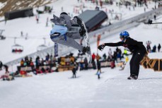 Businessman's nosegrab during the Mini Pipe World Champs held in spring at Cardrona ski field, Cardrona Valley, Wanaka, New Zealand.