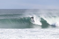 A surfer knifes in during a punchy spring swell at Blackhead, Dunedin, New Zealand.