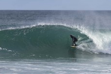 A surfer makes the most of a punchy spring swell at Blackhead, Dunedin, New Zealand.