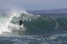 A surfer makes the most of a punchy spring swell at Blackhead, Dunedin, New Zealand.