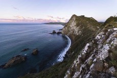 Nugget Point is a prominent headland on the Catlins coast in New Zealand. It is famous for its historic lighthouse and rocky islets known as "The Nuggets". Visitors can take an easy walk to a viewing platform for panoramic views of the ocean and the lighth